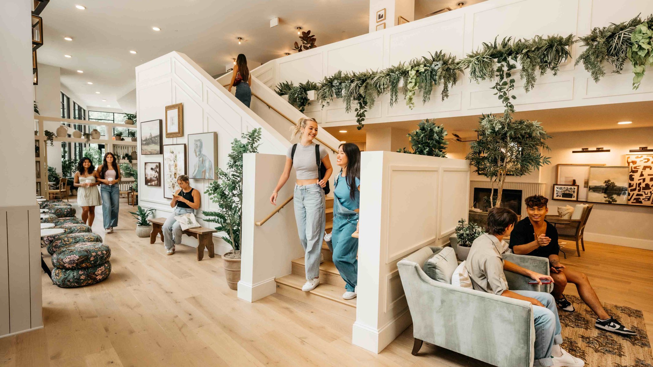 Girls walking down stairs in Rambler Athen's lobby.