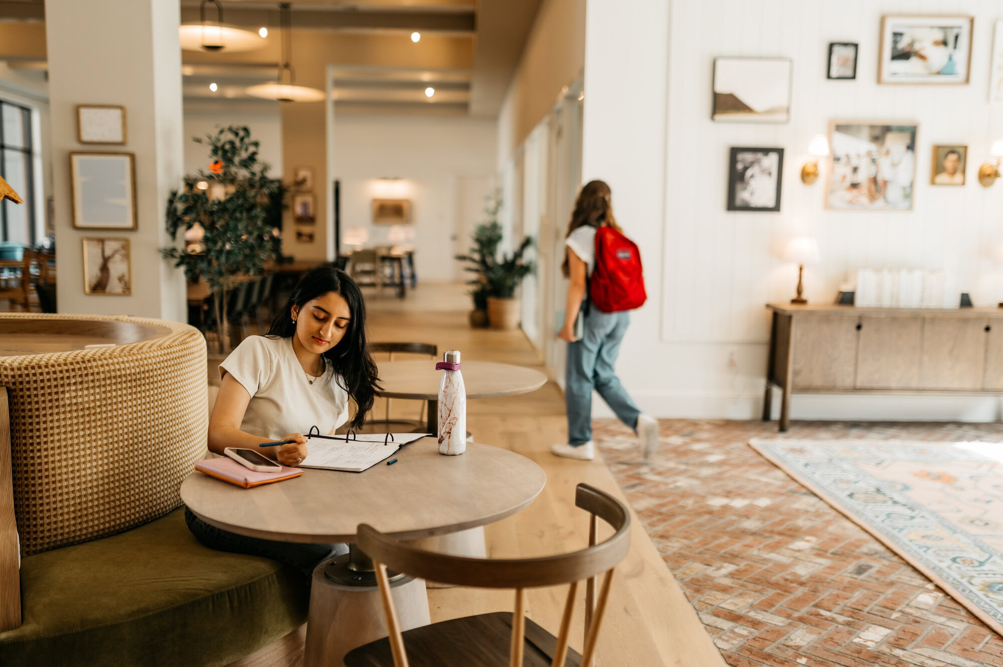 girl taking notes and studying at Rambler Athens