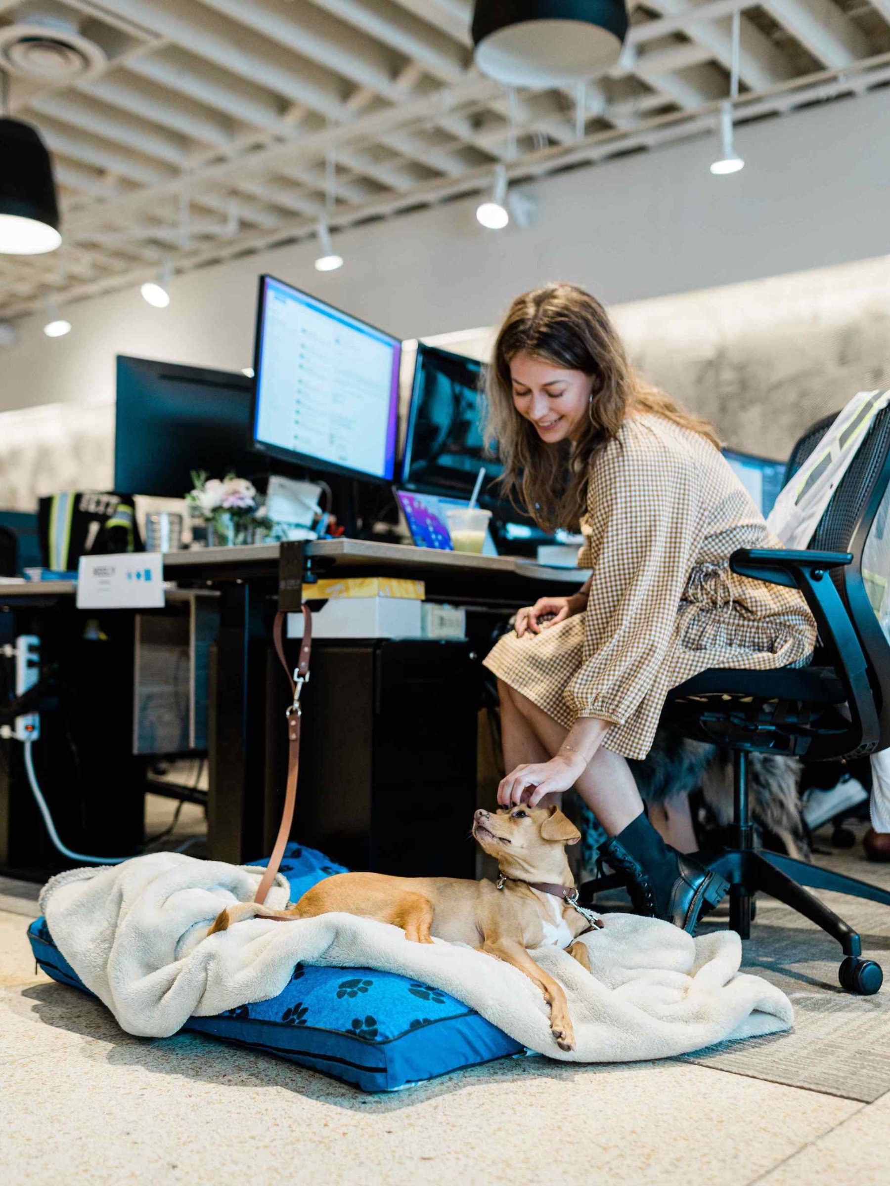 Keely Doering, Director of Corporate Operations petting her dog, Kekoa