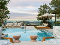 Image of Moontower's rooftop pool deck overlooking the downtown Phoenix skyline.