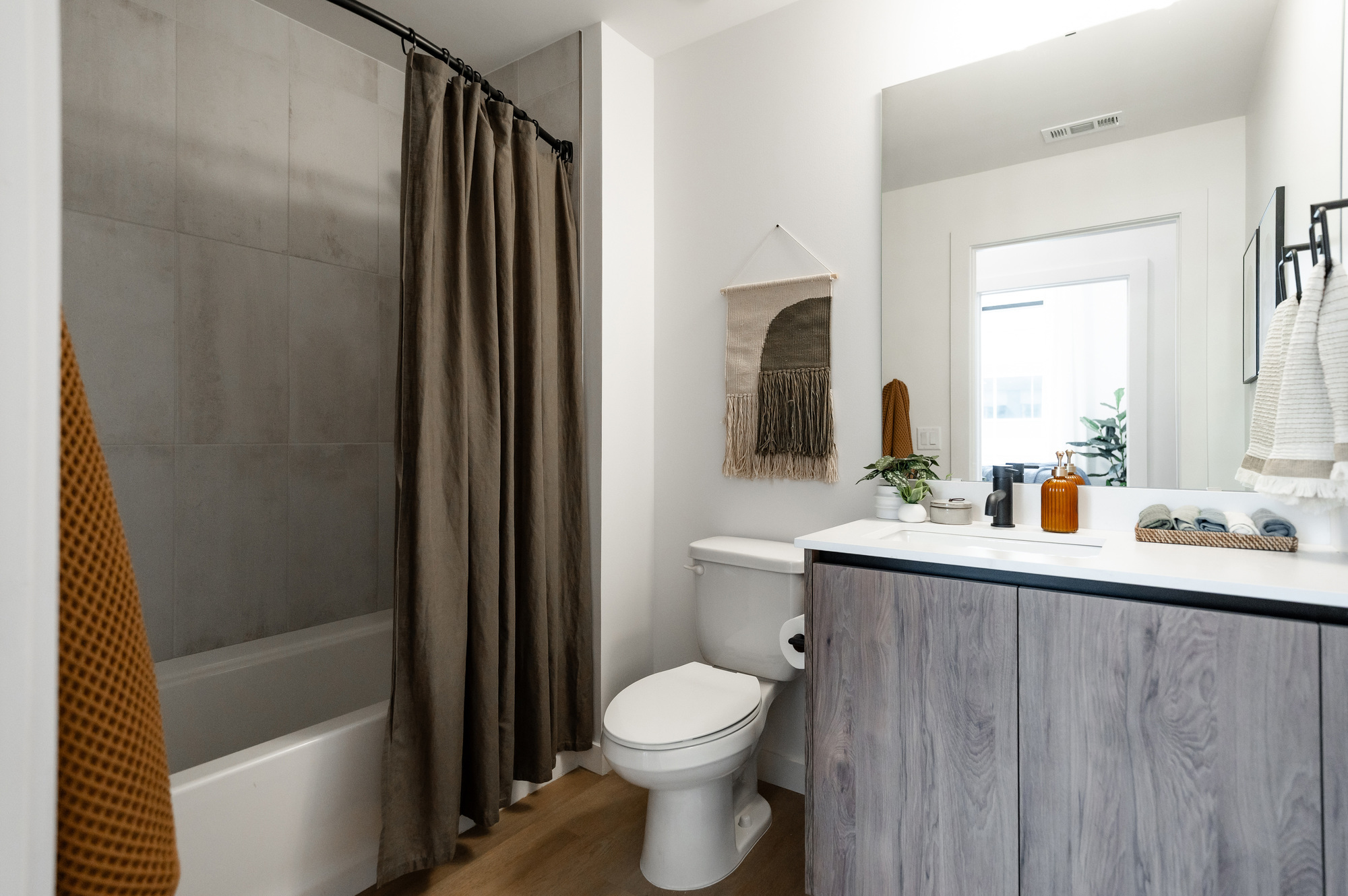 Representative bathrooms with a shower/tub combo at Rambler Atlanta.