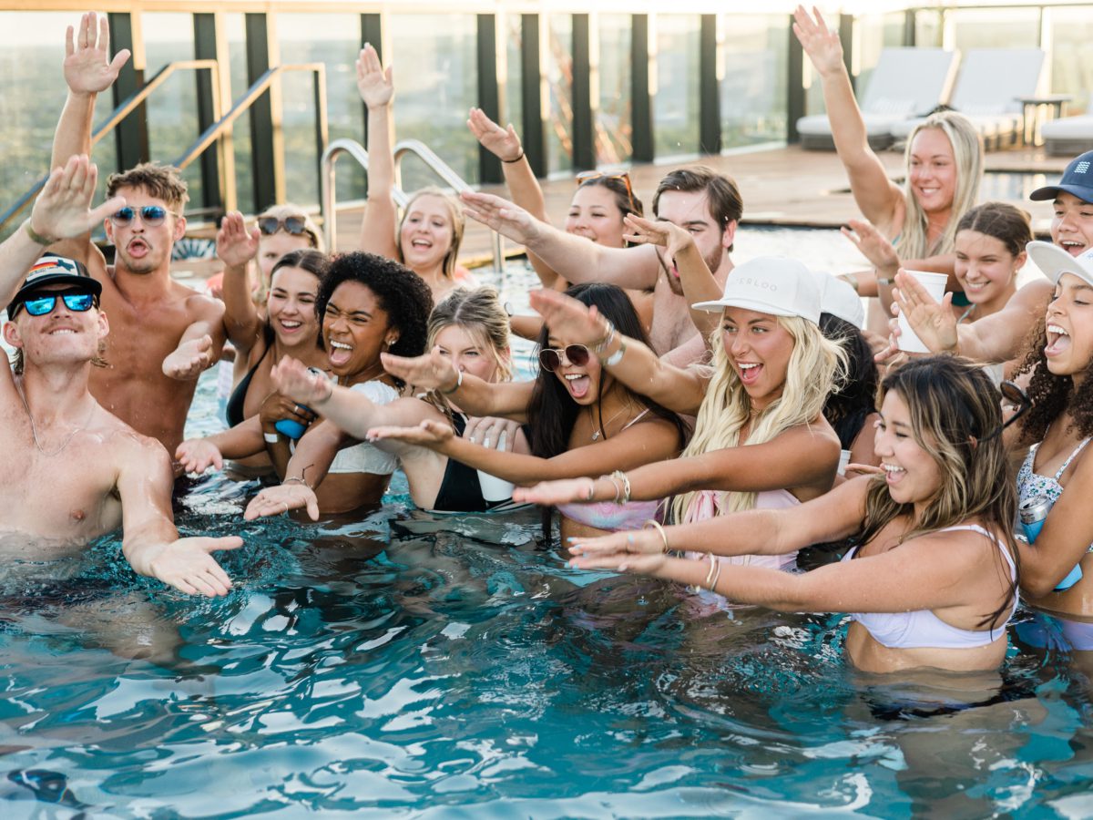 residents in swimming pool doing UF gator arms