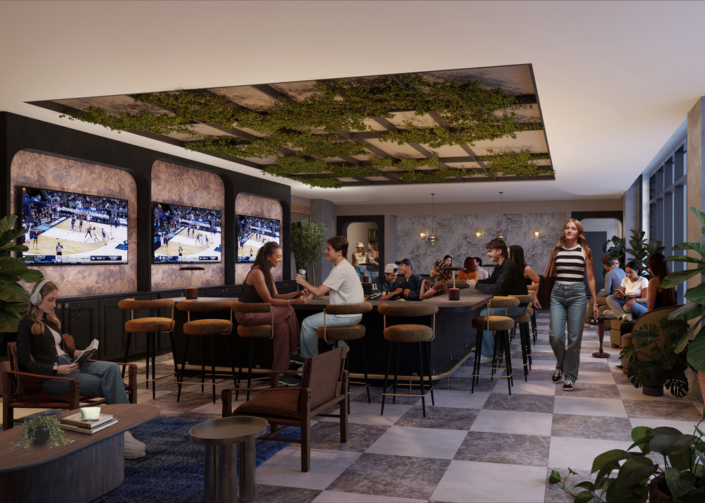 A modern lounge at Rambler Riverfront with people sitting at tables and the bar, watching basketball games on three large screens. The room features greenery on the ceiling, contemporary decor, and a relaxed, social atmosphere.