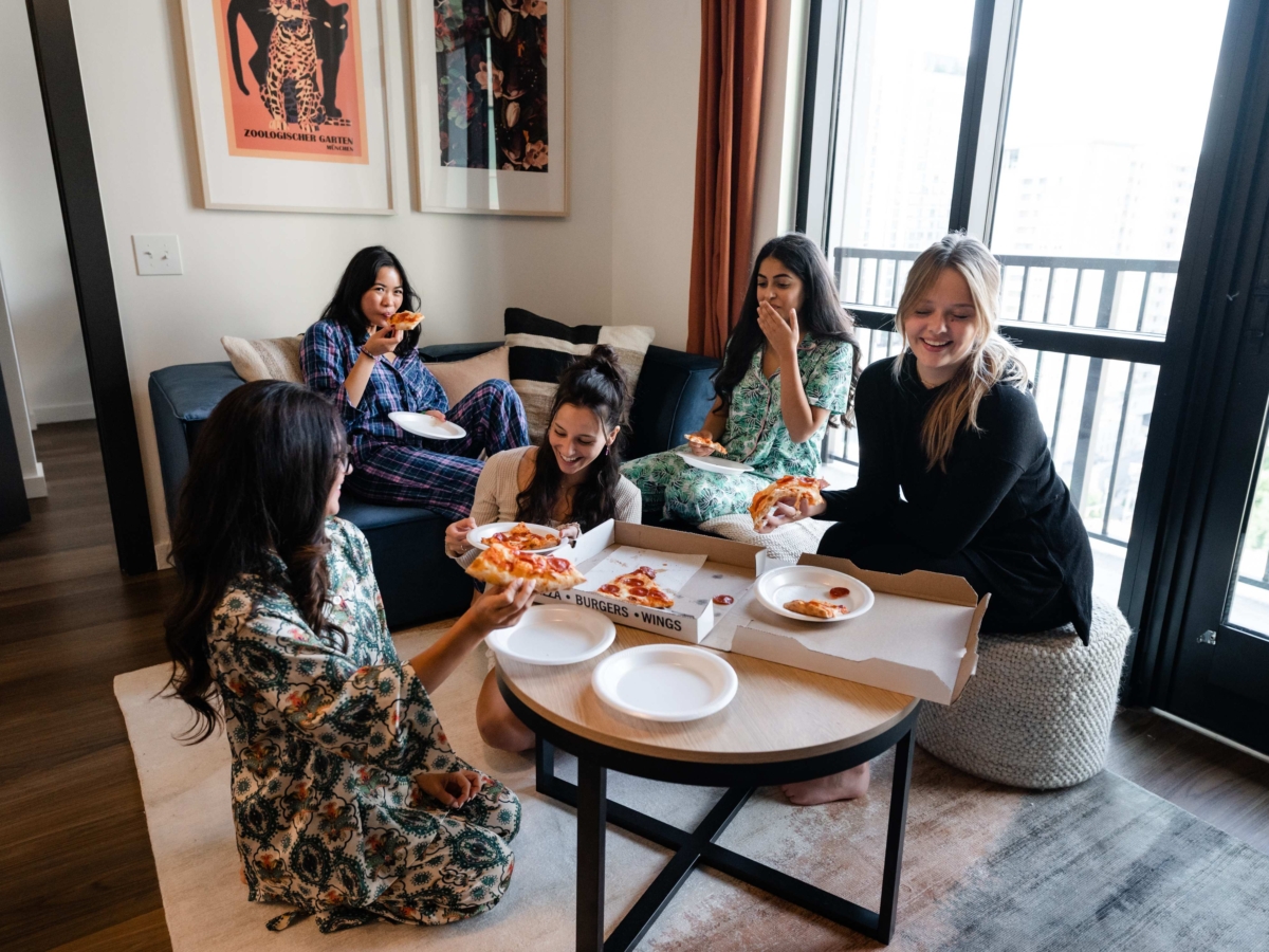students eating pizza in their apartment at Whistler Atlanta