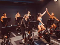 Girls high fiving at Rambler ATX Spin Room