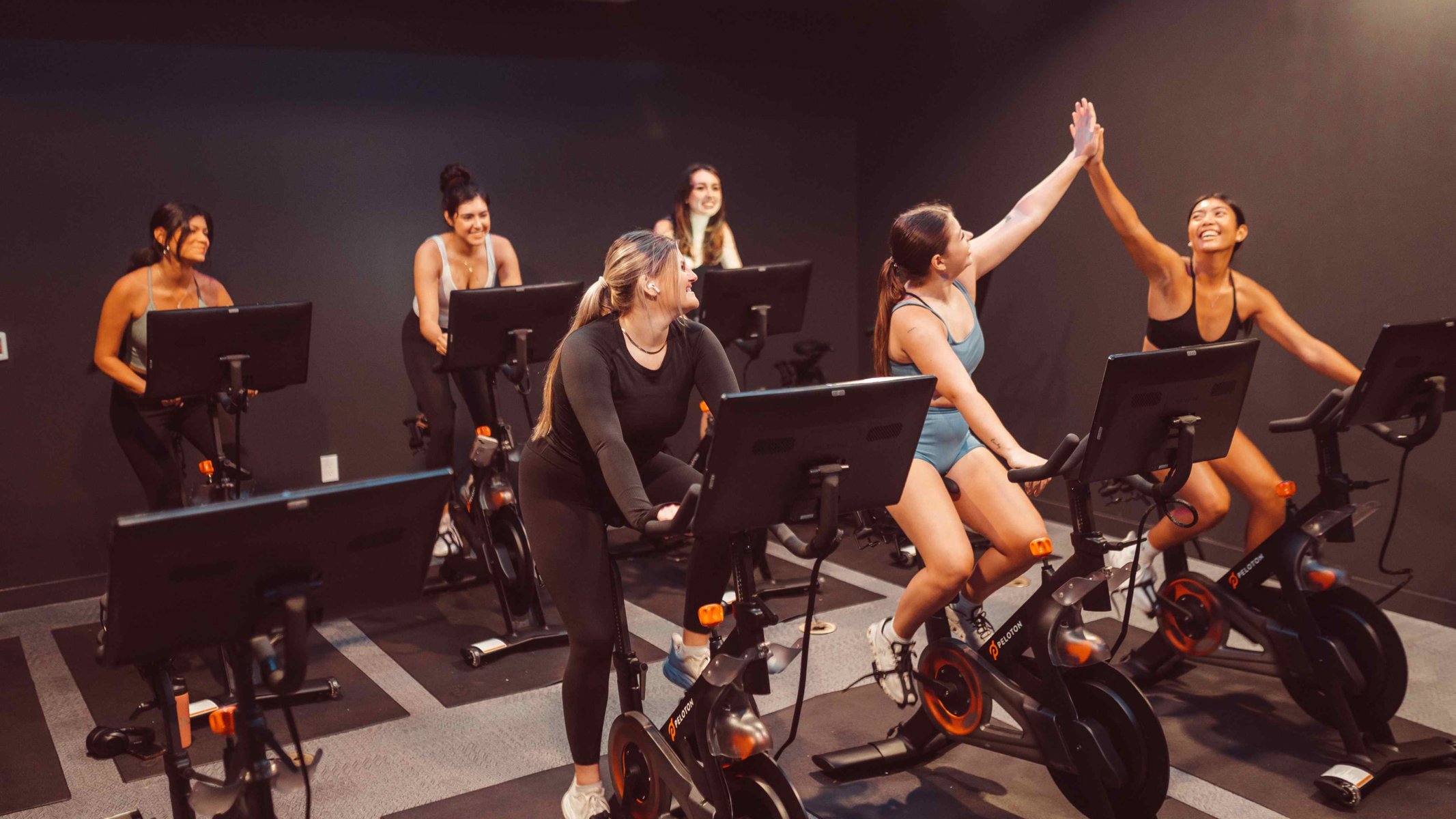Girls high fiving at Rambler ATX Spin Room