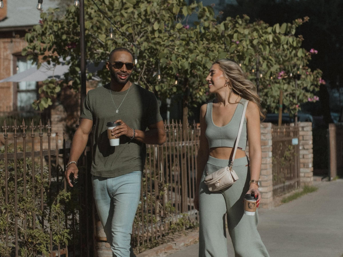 Two Phoenix residents walking with coffee
