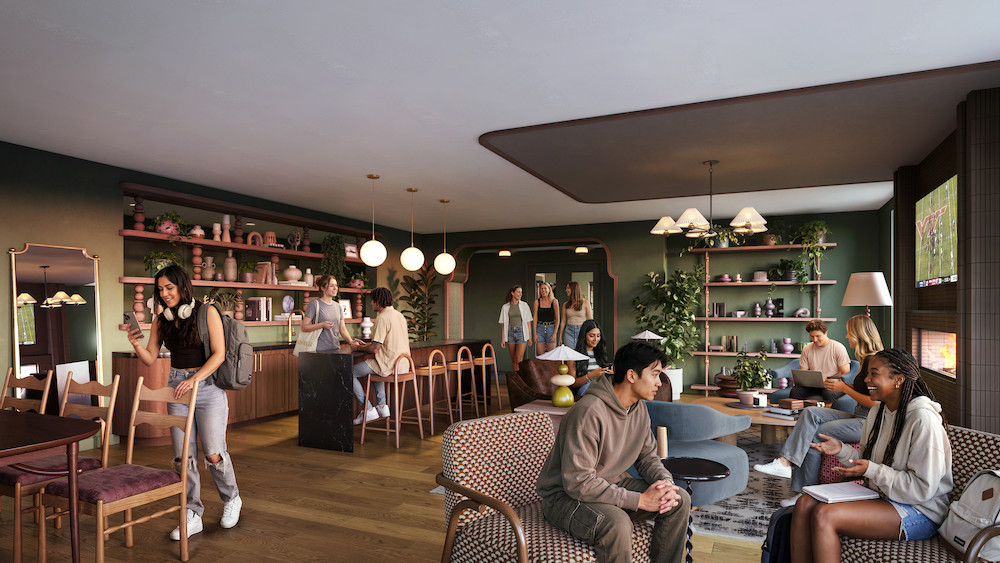 People sit, talk, and work on laptops in a cozy, modern café with green walls, wooden floors, plants, and shelves of decor. A barista serves drinks at the counter; a TV and fireplace are visible—creating an inviting atmosphere reminiscent of the communal areas found at Rambler Blacksburg student housing.