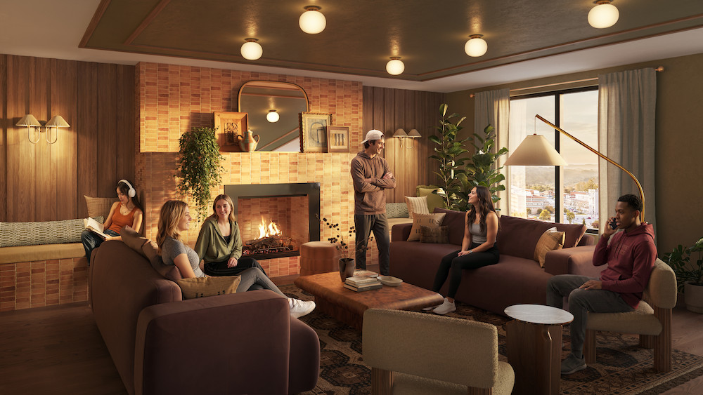 Six people relax and chat in a cozy living room at Rambler Blacksburg student housing, with a lit fireplace, brown sofas, indoor plants, and large windows offering a stunning city view.