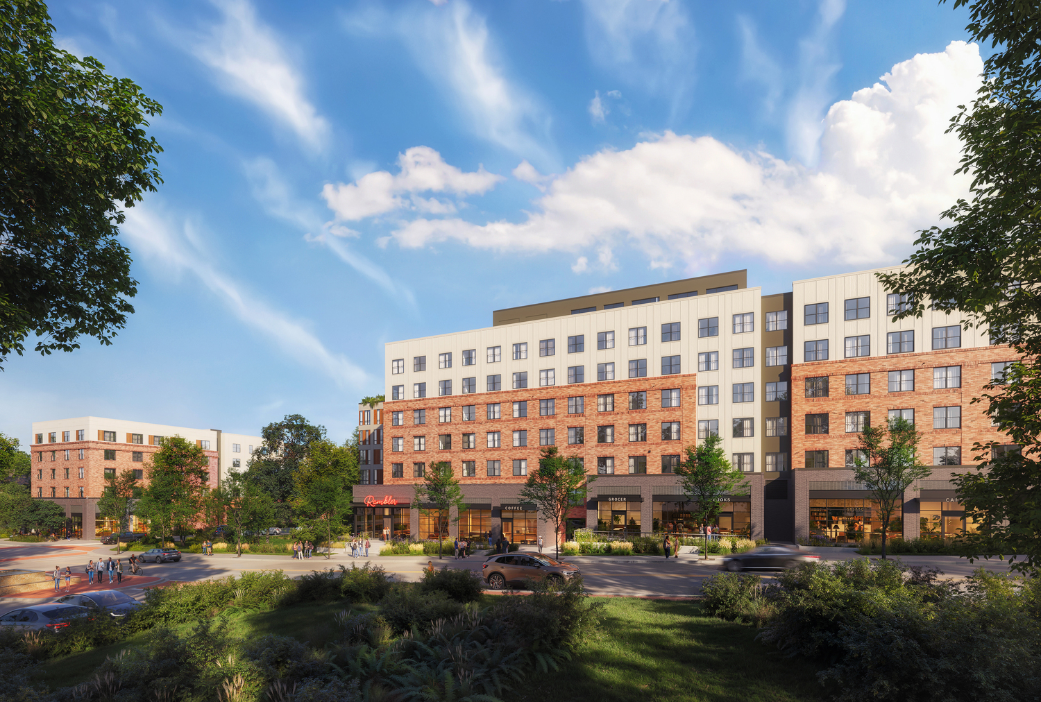 A modern mid-rise apartment building with brick and light-colored panels, surrounded by trees and landscaping, with people walking and cars parked along the street under a blue sky with scattered clouds.