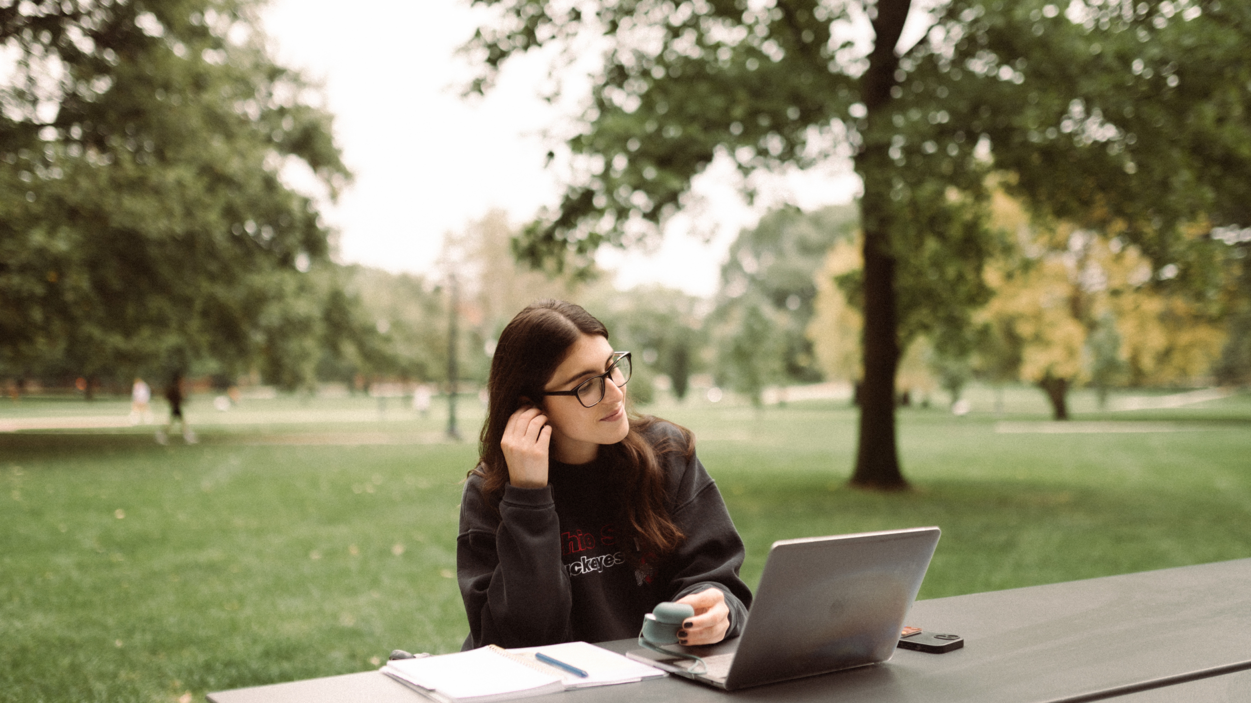 Student using their computer at Ohio State University, near Rambler Columbus.